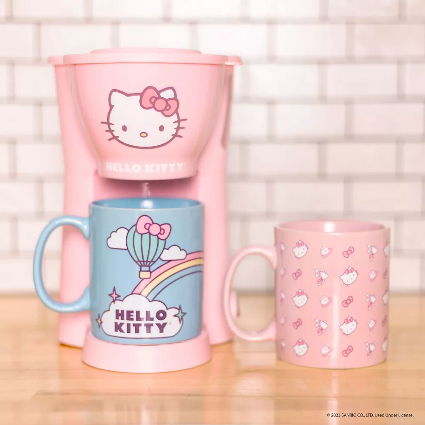 https://mycollectorsoutpost.com/cdn/shop/files/hello-kitty-sanrio-single-cup-coffee-maker-with-mugs2_1445x.jpg?v=1699984973