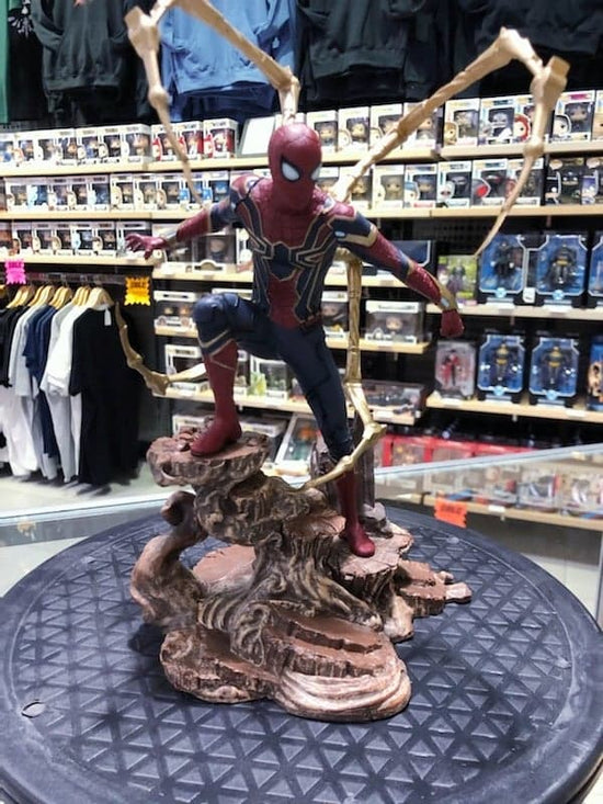 Load image into Gallery viewer, Photo of Iron Spider Spider-Man Gallery Statue by Diamond Select Toys. Spider-Man is posed on a rock formation in his Iron-Spider suit as seen in Avengers: Infinity War.
