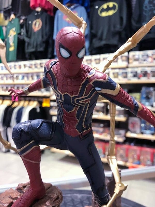 Load image into Gallery viewer, Photo of Iron Spider Spider-Man Gallery Statue by Diamond Select Toys. Spider-Man is posed on a rock formation in his Iron-Spider suit as seen in Avengers: Infinity War

