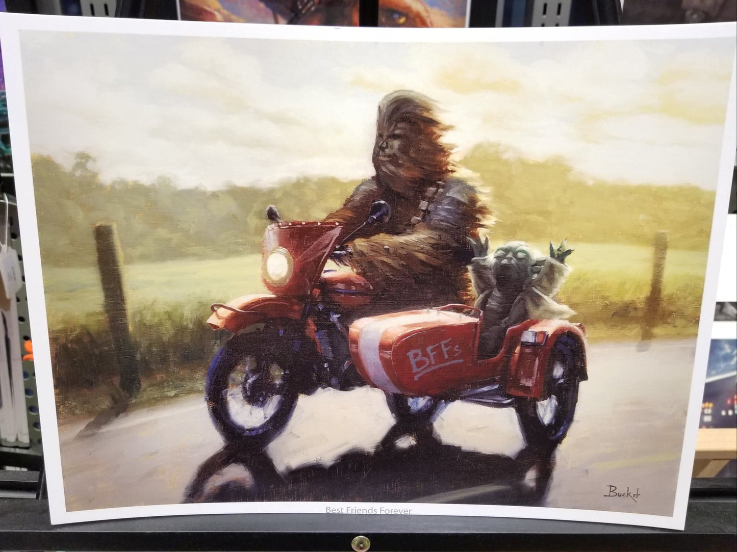 "Best Friends Forever" Art Print by Bucket   Yoda and Chewbacca have known each other for a LONG time.  Here the two dear friends have taken a well-deserved day off to ride through the countryside on a gorgeous sunny day in a vintage red motorcycle with sidecar.  Our favorite details in this art? Look at the joy on Yoda's face, and the pride in Chewbacca's expression. Chewie is no copilot here—the bike is all his!