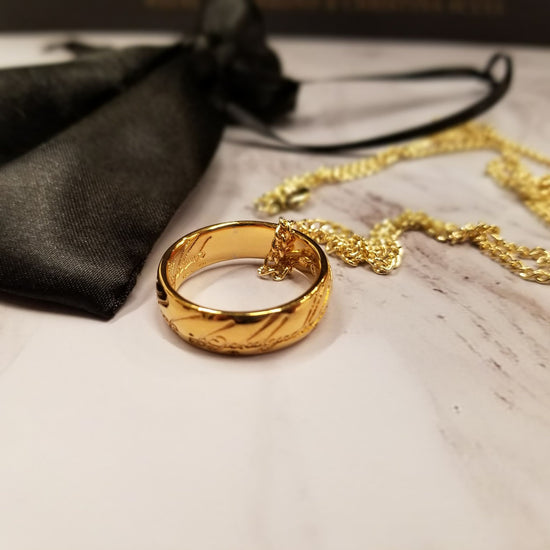 The One Ring, also called The Ruling Ring and Isildur's Bane, is crafted in solid bronze by the Badali Jewelry artists and then barrel plated with pure 24k gold. Each One Ring pendant has the appearance of solid gold, hence the name, Gollum Gold. Our Gollum Gold One Ring appeared in an episode of The Big Bang Theory. 