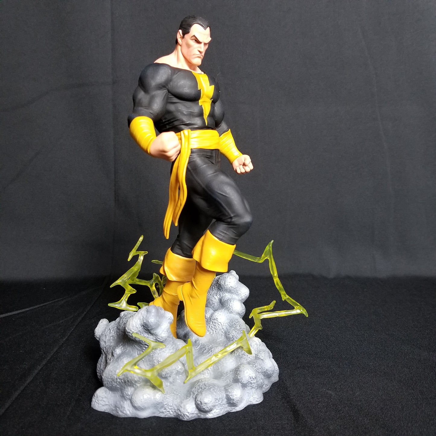 Getting ready for his big-screen debut, Black Adam smashes his way out of the Shazam/Captain Marvel mythos and into the DC Gallery Diorama line of sculptures! Hovering above the ground with lightning crackling around him, this approximately 11-inch sculpture of Teth-Adam features a removable cape, and is made of high-quality PVC with detailed sculpting and paint applications.
