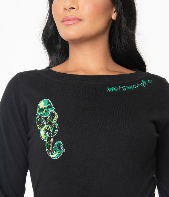 Harry Potter The Dark Mark Sweater by Unique Vintage  Cursed with cuteness, dolls! This deadly knit top from Unique Vintage is crafted in a silky soft black knit fabric.  The wide bateau neckline features the terrifying skull and serpent dark mark from Harry Potter and magic words ‘Morsmordre’ in green embroidered accent. Features slender three-quarter length sleeves and stay-in-place hem