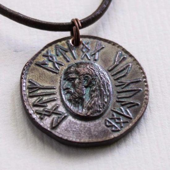 Load image into Gallery viewer, Dwarven Axe of Durin coin pendant necklace from the The Lord of the Rings by J. R. R. Tolkien is struck from solid copper. It is presented on a 30&amp;quot; leather cord. Coin artwork by Greg Franck-Weiby.  This coin is treated to look as if they have been handled and circulated. This process is done by hand, and it is both an art and a science. Coloring and patinas will vary. No two coins are exactly the same! Coins are struck one at a time in the USA using antique machinery and traditional coining techniques. 
