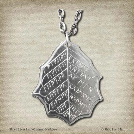 This Elvish Mithril Leaf of Spring Necklace is crafted in celebration of The Lord of the Rings by J. R. R. Tolkien. The leaf-shaped coin is struck from solid silver, measures 2.7 cm in diameter, and weighs about 6.5 grams. Includes a 30" antique bronze cable chain with clasp. Coin artwork by Greg Franck-Weiby.  Coins are struck one at a time in the USA using antique machinery and traditional coining techniques. A colorful description is included with history, translations, and facts about the coins.