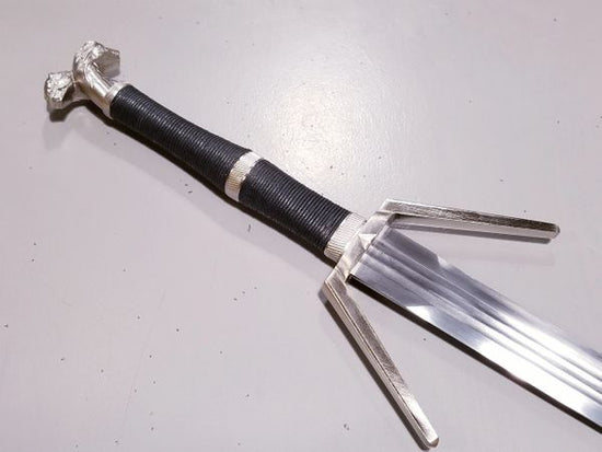 Load image into Gallery viewer, In The Witcher games, novels, and now Netflix adaptation - Geralt of Rivia&amp;#39;s iconic Silver sword is said to be for monsters. This recreation is as stunning to hold in person as it is to look at! A specially crafted black sheath is included for this steel prop replica of Geralt&amp;#39;s Silver Sword.
