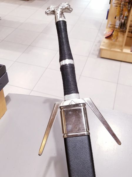Load image into Gallery viewer, In The Witcher games, novels, and now Netflix adaptation - Geralt of Rivia&amp;#39;s iconic Silver sword is said to be for monsters. This recreation is as stunning to hold in person as it is to look at! A specially crafted black sheath is included for this steel prop replica of Geralt&amp;#39;s Silver Sword.

