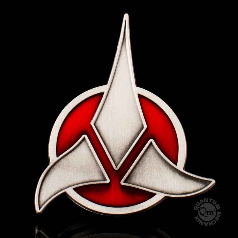 Star Trek Klingon Emblem Wearable Magnetic Badge  This symbol strikes terror across the Alpha Quadrant and signifies the uniting of the Klingon peoples into a mighty empire. It originated in the times of the ancient hero, Kahless and his conquests. Made of a hefty zinc alloy and inlaid with red enamel, this 2-inch quality badge of the emblem of the Klingon Empire can be worn proudly by any honorable warrior.